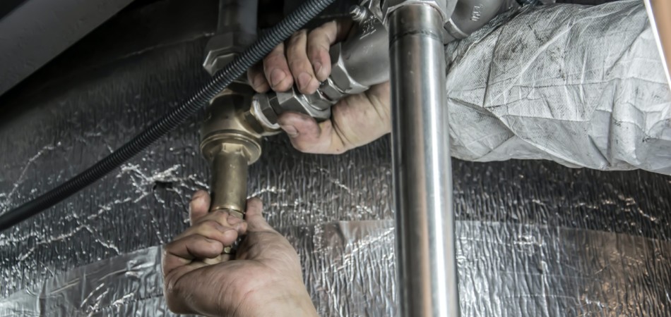 Plumber or drainage expert hands fixing pipes